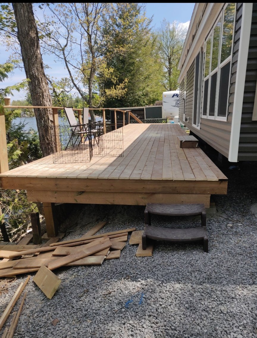 Wood deck beside a home overlooking the lake